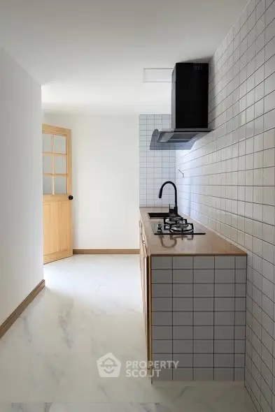 Modern minimalist kitchen with gas stove and sleek design