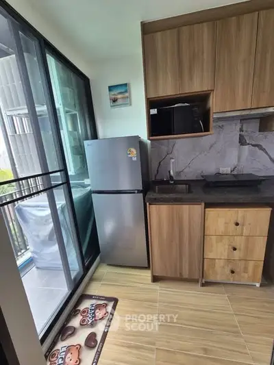 Modern kitchen with sleek appliances and balcony view