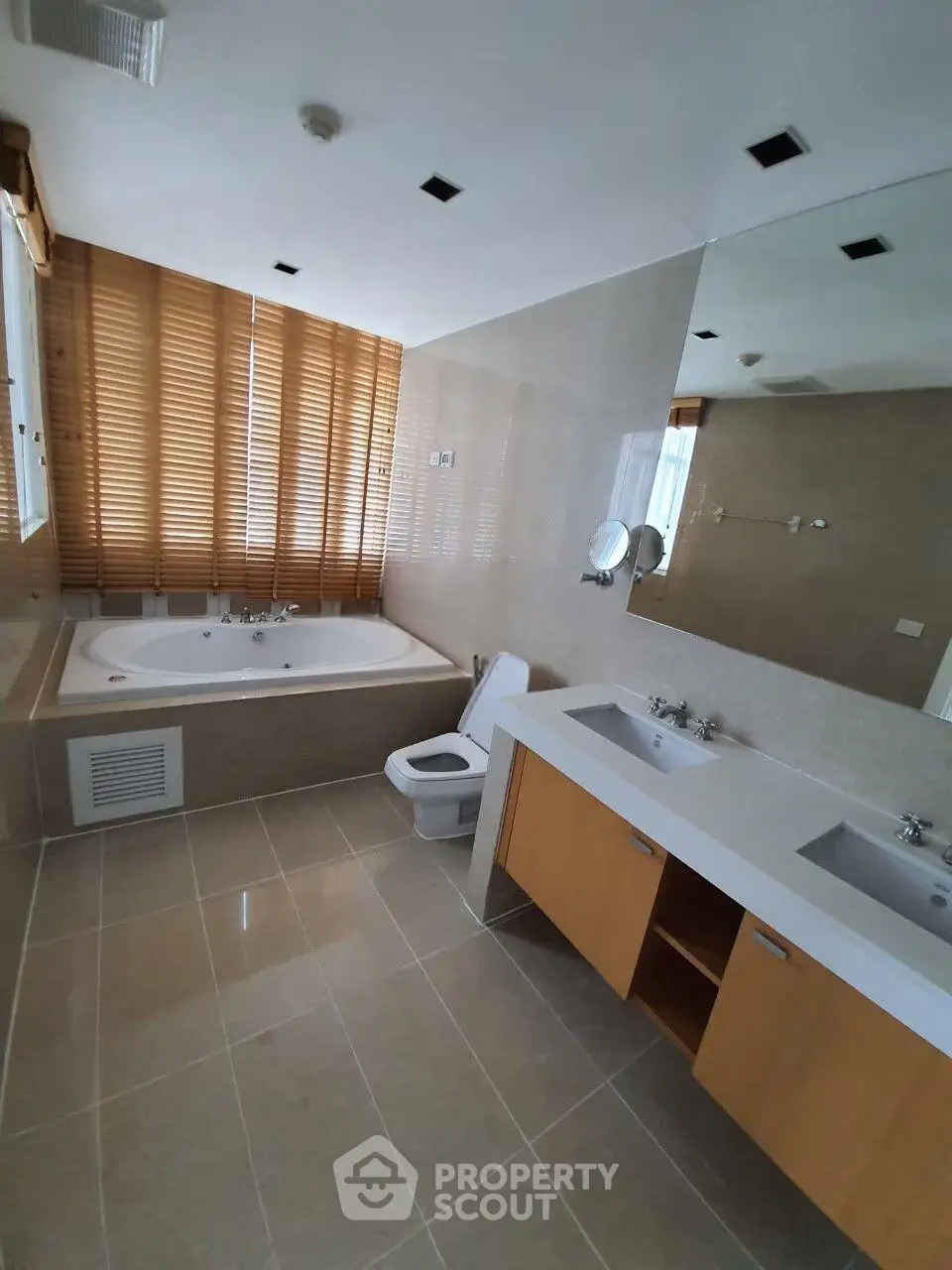 Spacious modern bathroom with large bathtub and dual sinks
