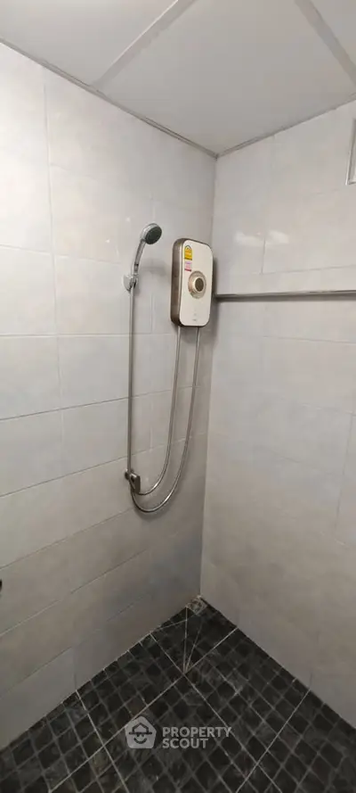 Modern bathroom with sleek shower and tiled walls in a contemporary home.