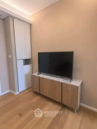 Modern living room with sleek TV stand and wooden flooring