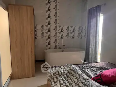 Cozy bedroom with modern bathtub and stylish decor