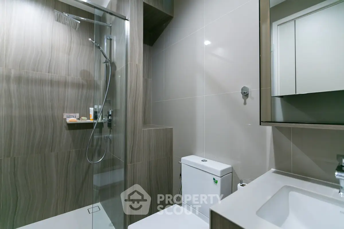 Modern bathroom with glass shower and sleek fixtures
