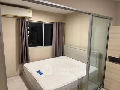 Cozy bedroom with sliding glass doors and air conditioning in modern apartment.