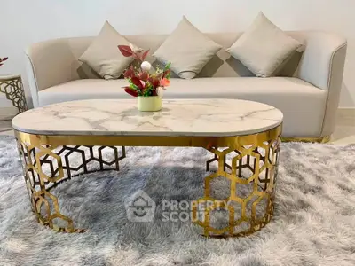 Elegant living room with modern sofa and stylish marble coffee table on plush rug.