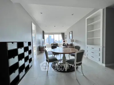 Spacious living room with elegant dining area and city view