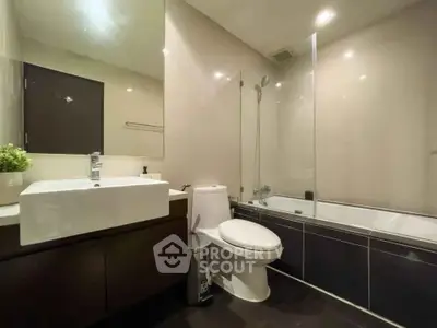 Modern bathroom with sleek fixtures and bathtub in a contemporary apartment.