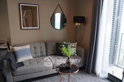 Stylish living room with modern decor and balcony view, perfect for urban living.