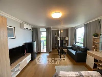 Spacious living room with modern decor and large windows for natural light.