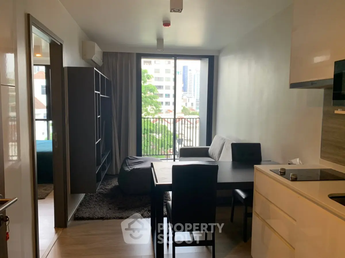 Modern apartment living room with dining area and city view balcony.