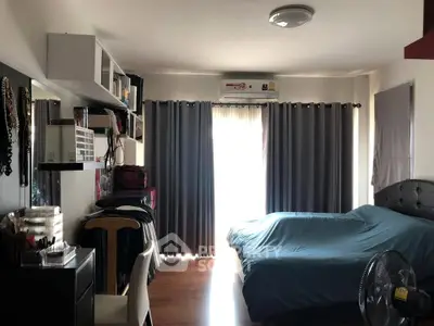 Cozy bedroom with modern decor and ample natural light