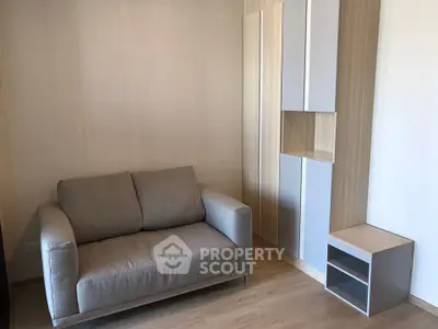 Cozy living room with modern sofa and stylish storage unit in a minimalist design.