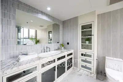 Luxurious modern bathroom with marble countertops and elegant cabinetry.