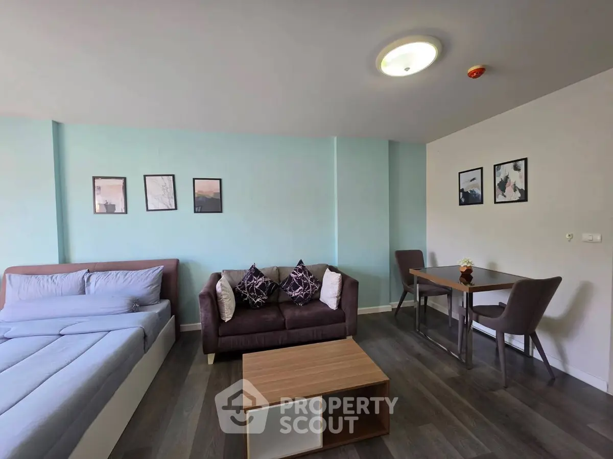 Modern studio apartment with cozy living area and stylish decor