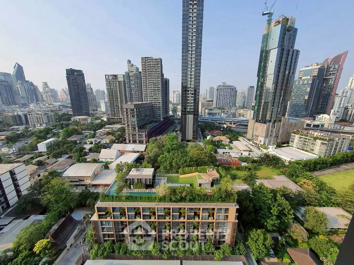 Stunning cityscape view showcasing modern high-rise buildings and lush greenery in urban setting.
