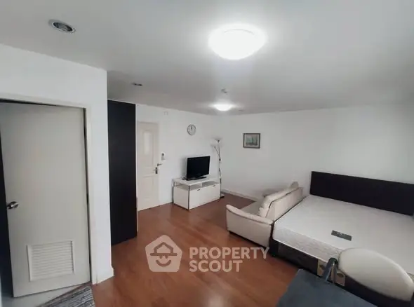 Spacious living room with modern decor and wooden flooring