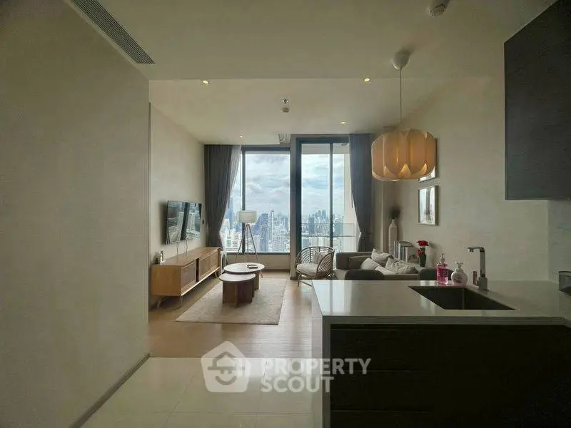 Luxurious living room with stunning city view, modern furniture, and elegant decor in high-rise apartment.