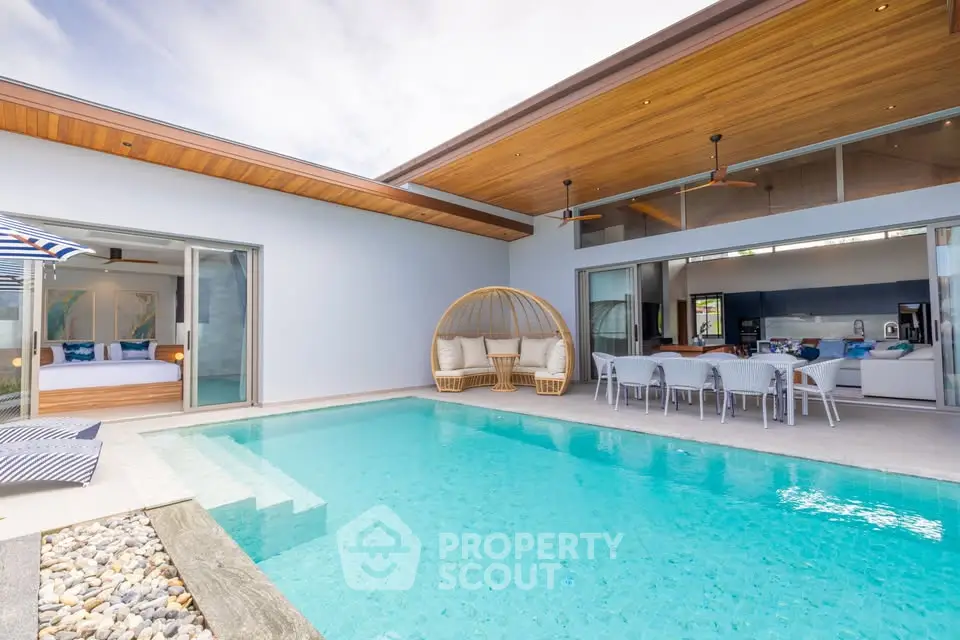 Luxurious modern villa with private pool and open-air dining area, perfect for relaxation and entertaining.