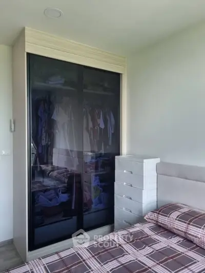 Modern bedroom with sleek wardrobe and stylish bedding
