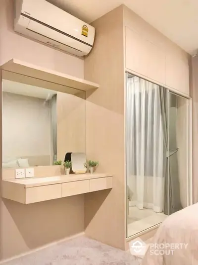 Modern bedroom with built-in wardrobe and air conditioning unit