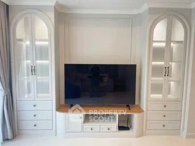 Elegant living room with built-in cabinets and modern TV setup