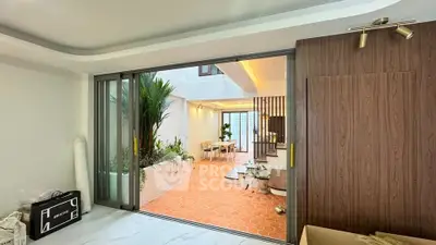 Spacious modern interior with sliding doors and indoor garden, perfect for stylish living.
