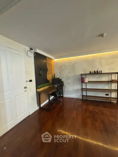 Modern study room with wooden flooring and sleek desk setup