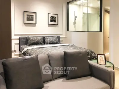 Modern studio apartment with stylish decor and cozy ambiance, featuring a comfortable bed and sleek furnishings.