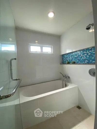 Modern bathroom with elegant bathtub and stylish tile accents