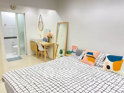 Modern bedroom with stylish decor and ensuite bathroom, featuring a cozy bed and chic furnishings.