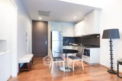 Modern kitchen with dining area, sleek appliances, and stylish decor in open layout.