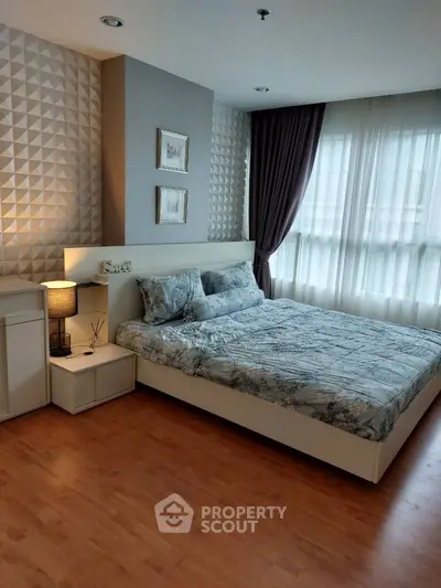 Elegant bedroom with modern decor and large window for natural light