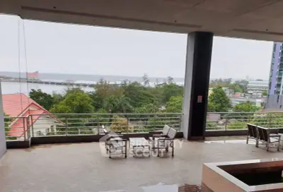 Spacious balcony with stunning ocean view and outdoor seating area.