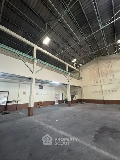 Spacious industrial warehouse with high ceilings and ample storage space.