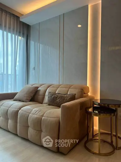 Luxurious living room with plush sofa and elegant lighting in modern apartment