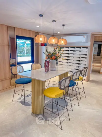 Stylish modern kitchen with vibrant bar stools and elegant pendant lighting