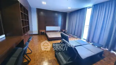 Spacious bedroom with parquet flooring and modern furnishings