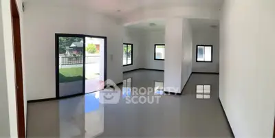 Spacious modern living room with large windows and garden view