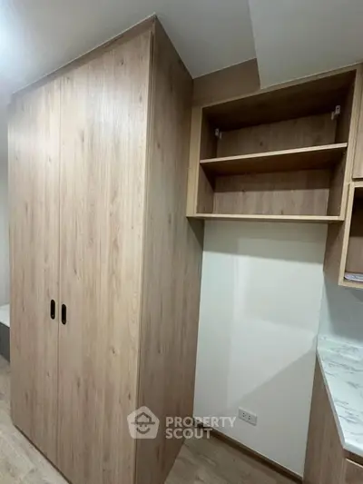 Modern wooden storage unit with open shelves in a stylish interior space.