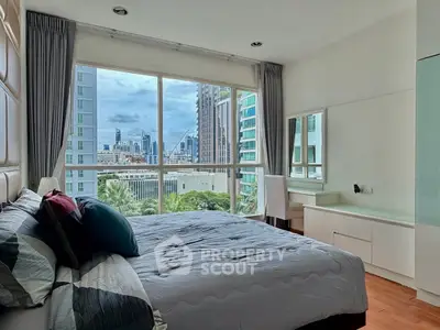 Spacious bedroom with city view and modern decor in high-rise apartment