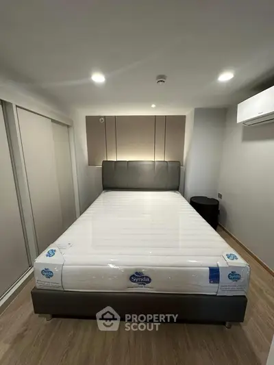 Modern bedroom with sleek design and new mattress in a stylish apartment.