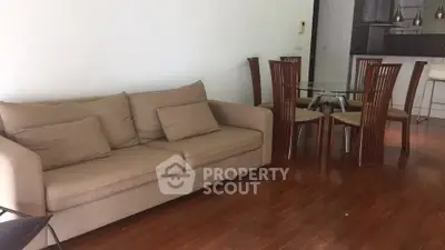 Spacious living room with elegant dining area and modern kitchen in open layout.