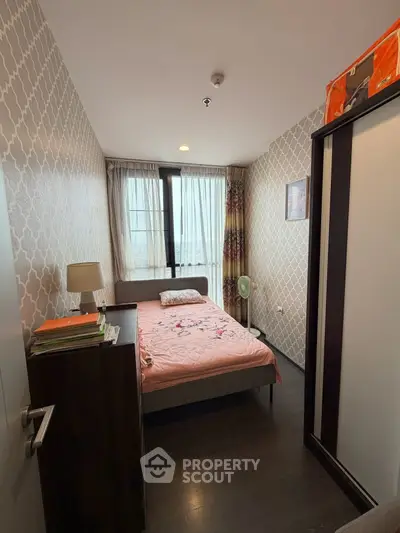Cozy bedroom with stylish wallpaper and natural light