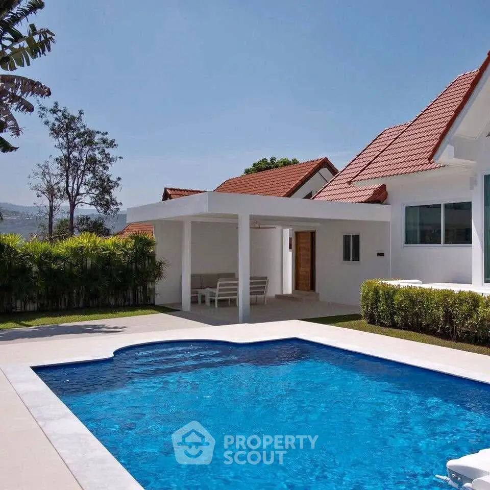 Luxurious villa with private pool and modern architecture under clear blue sky.