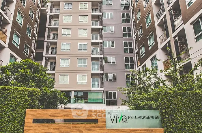 Modern condominium building with lush greenery at Viva Petchkasem 68.
