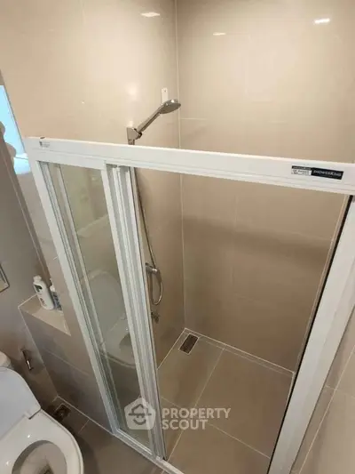 Modern bathroom with glass shower enclosure and sleek fixtures