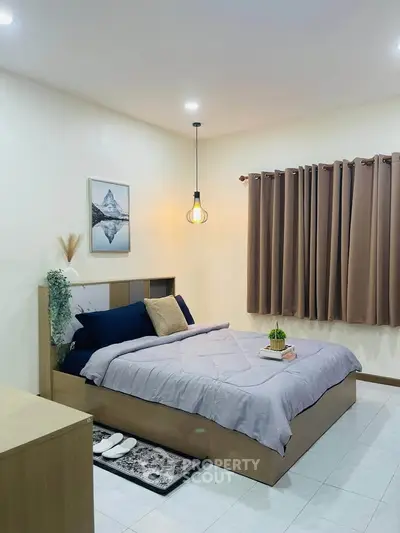 Cozy bedroom with modern decor and soft lighting, featuring a comfortable bed and stylish curtains.
