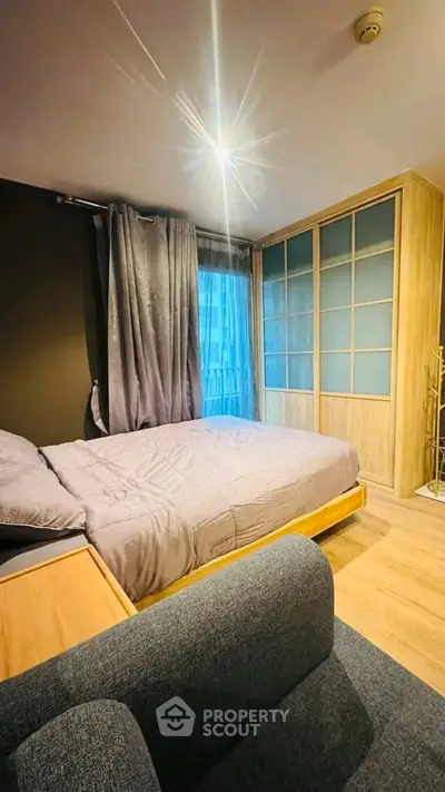 Modern bedroom with stylish decor and ample natural light