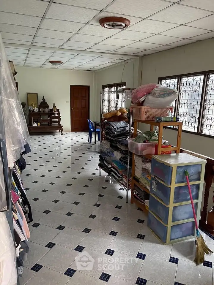 Spacious storage room with tiled floor and ample natural light, perfect for organizing household items.