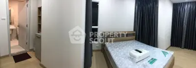 Spacious bedroom with modern decor and ensuite bathroom in a stylish apartment.